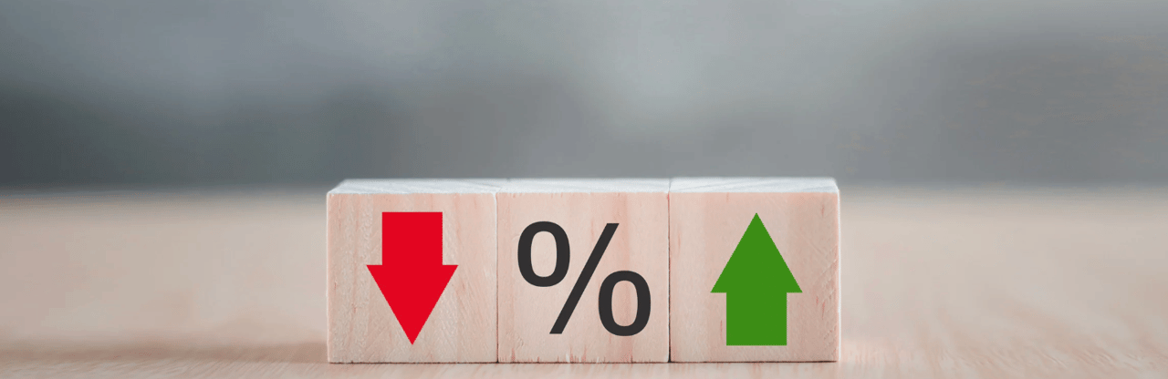 Wooden blocks show a red downward arrow, a percent sign, and a green upward arrow.