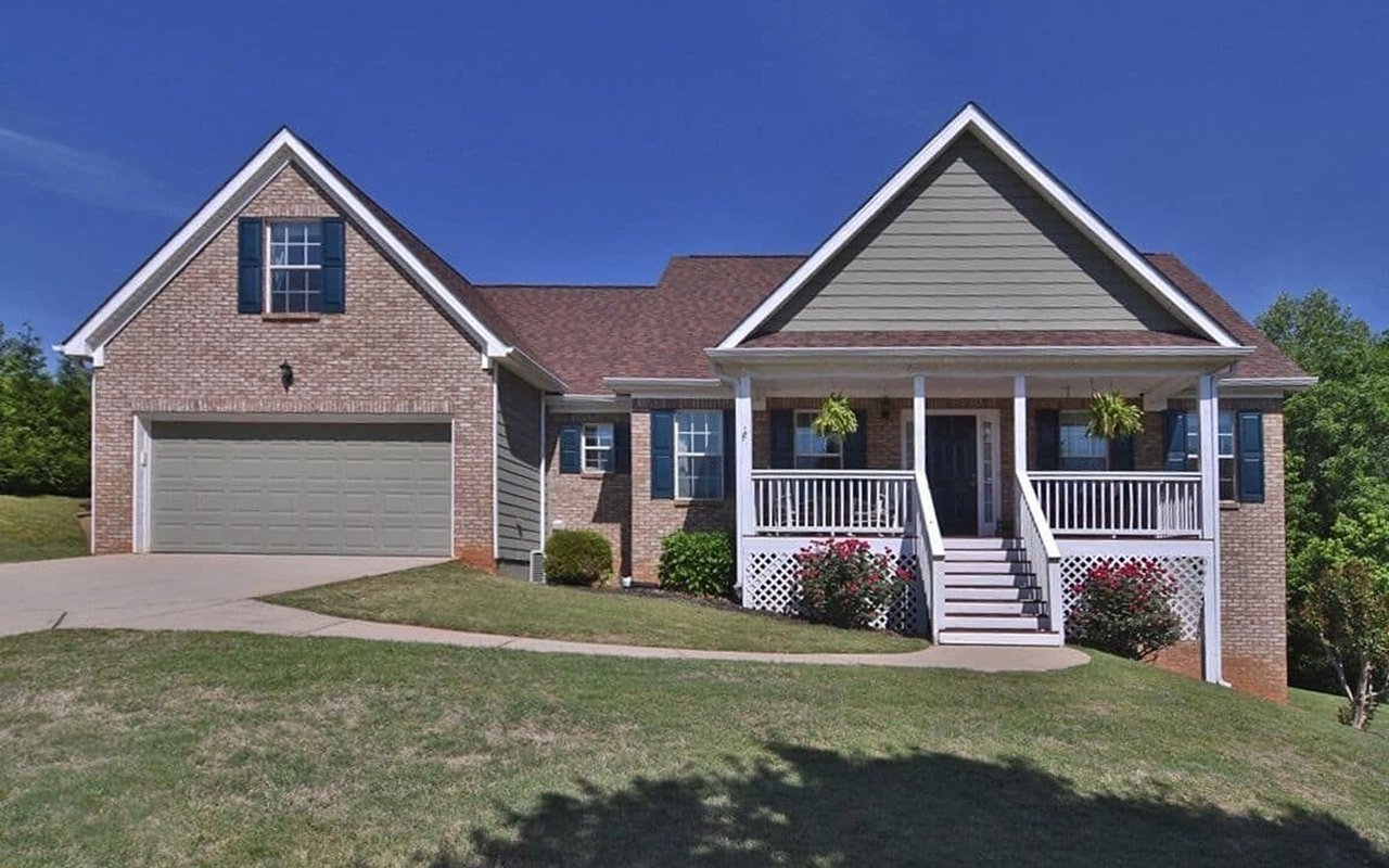 Brick ranch home with a two-car garage and a covered front porch.