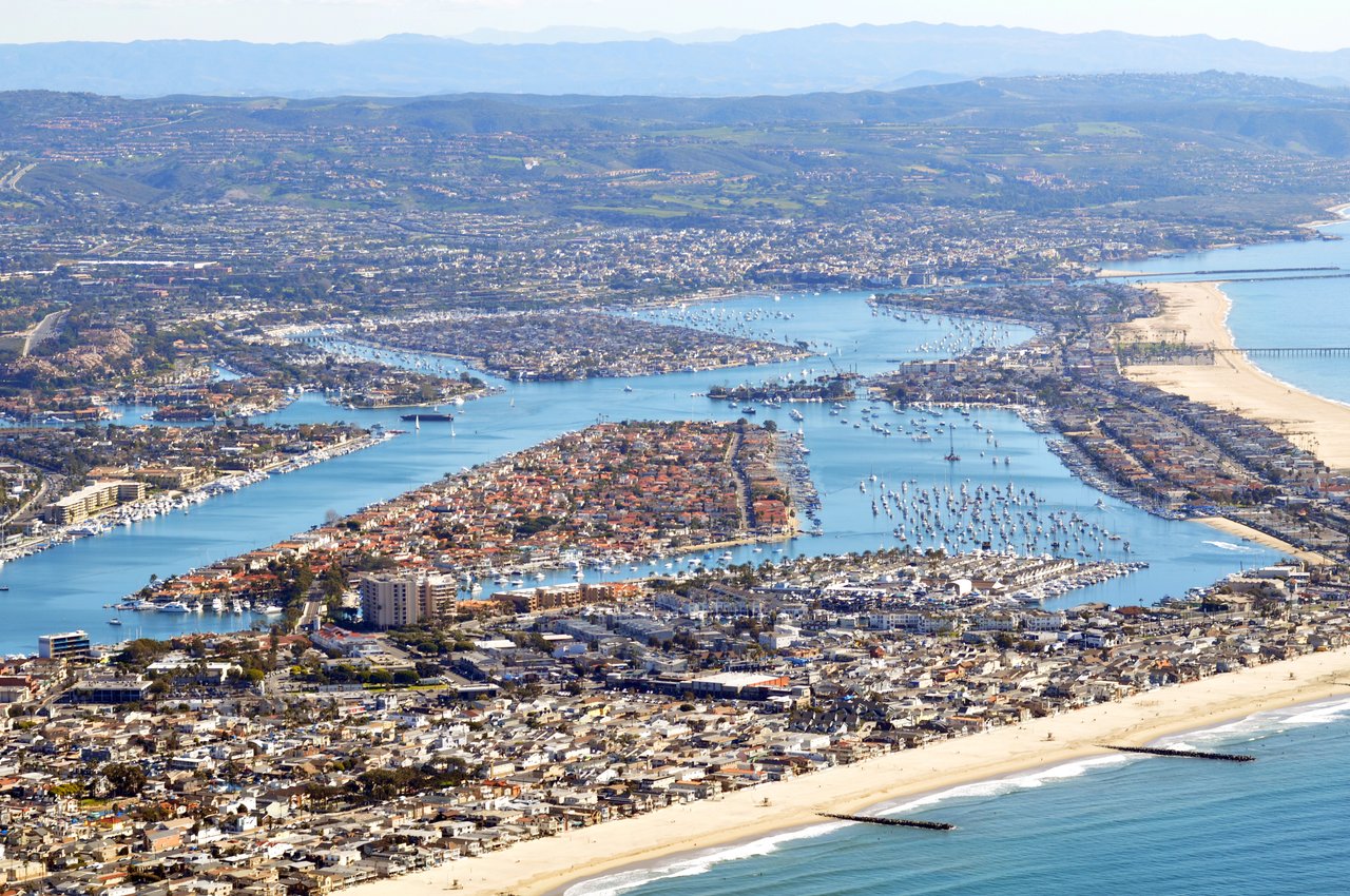 Aerial view of Balboa Island and Lido Isle luxury waterfront homes along Newport Harbor, Newport Beach, California
