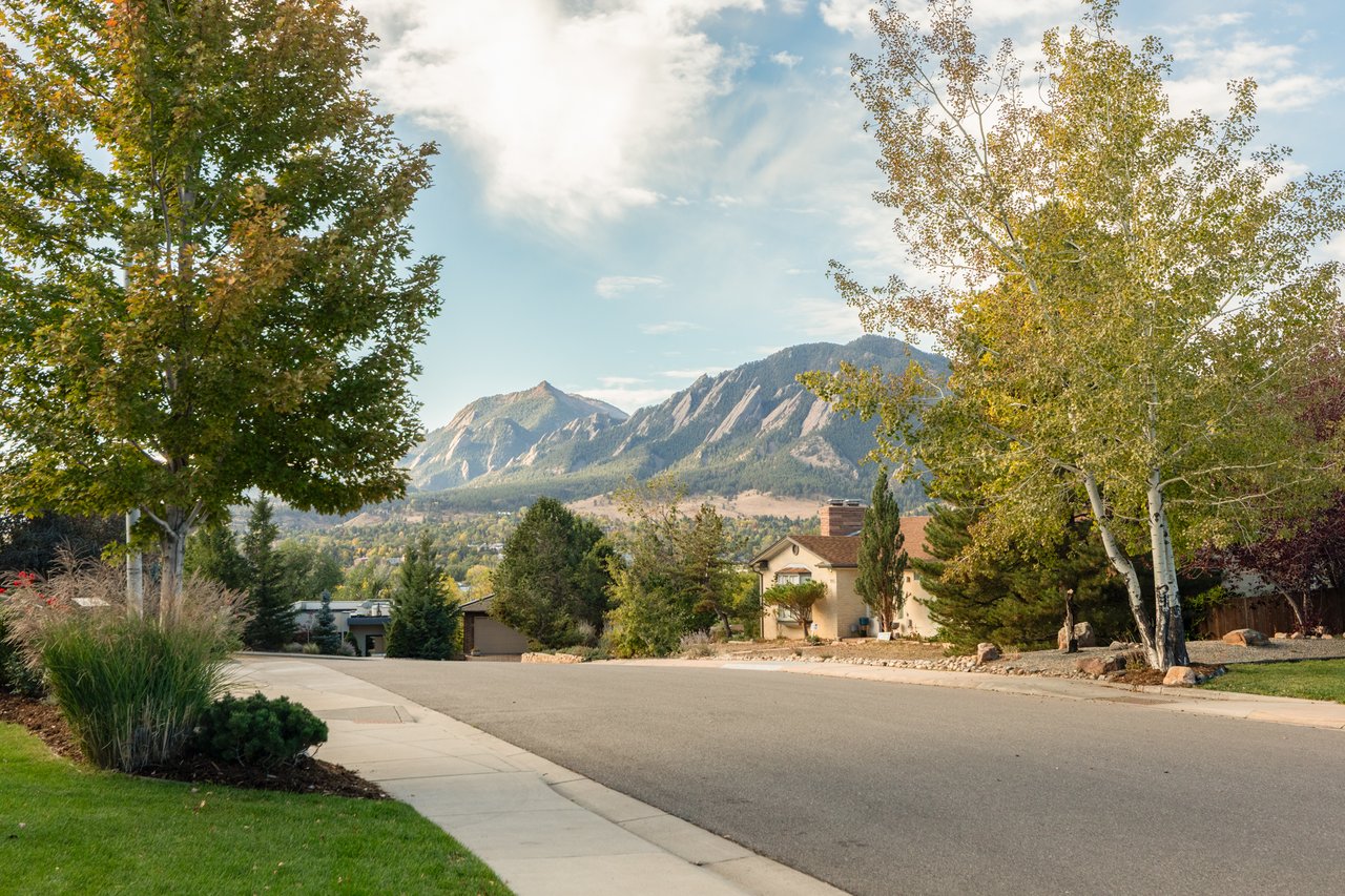 Tree-lined Balsam Drive in Boulder's Hillcrest neighborhood with the Flatirons in the distance