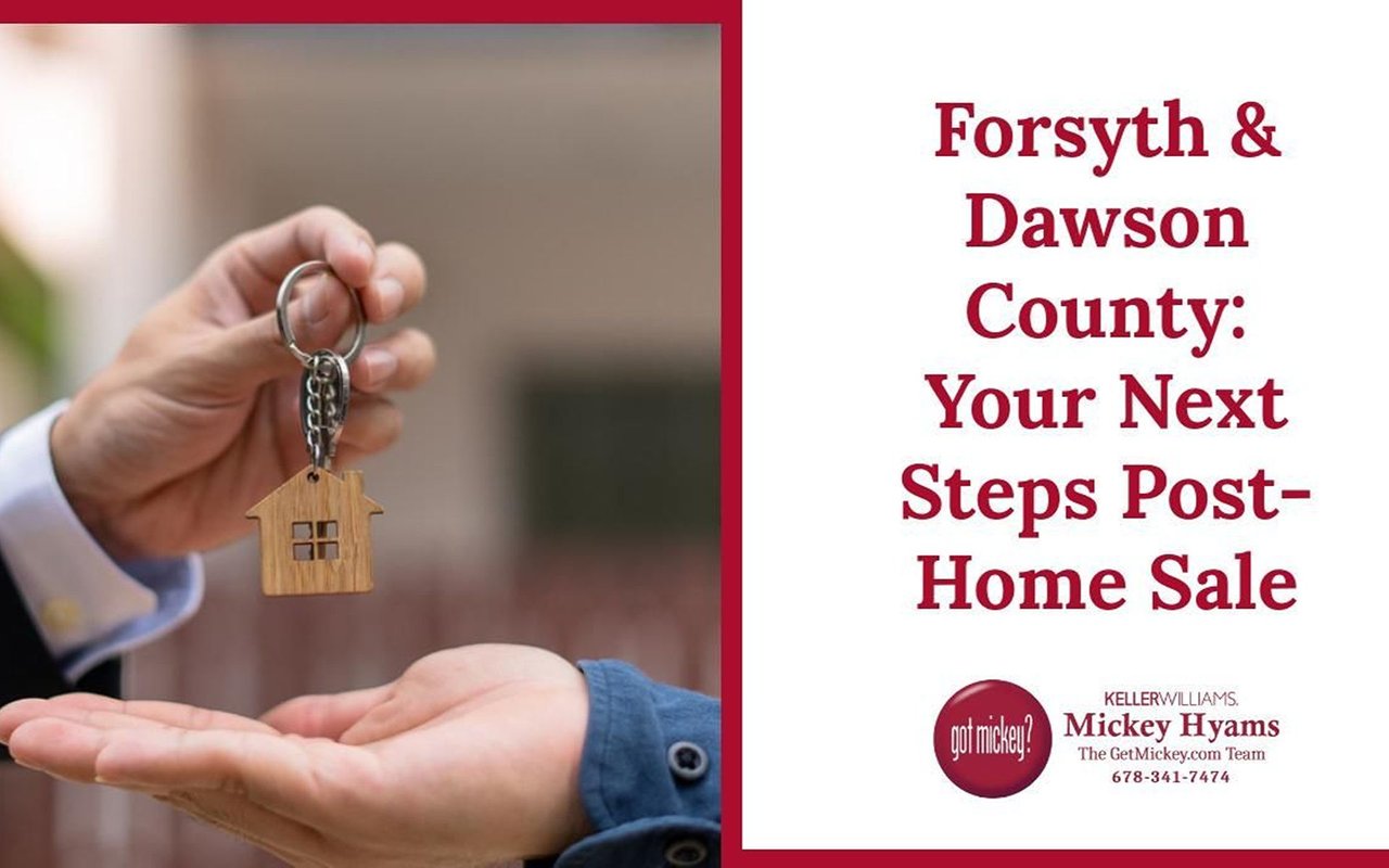 Forsyth & Dawson County: Your Next Steps Post-Home Sale; a house key is passed between two people.