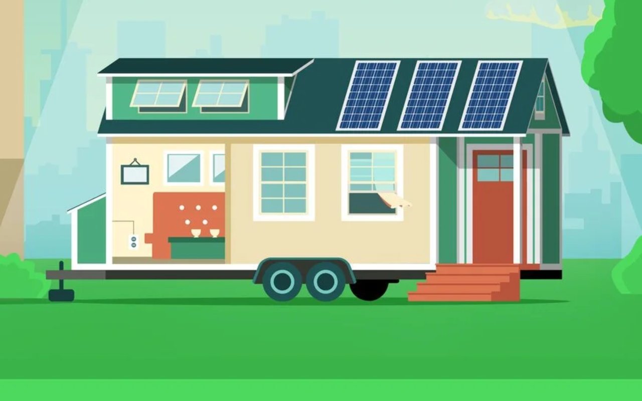 Tiny house on a trailer with rooftop solar panels and a visible compact interior.