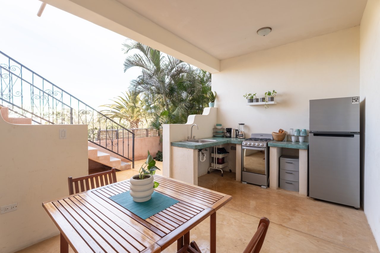 Outdoor kitchen and patio at The Studio House in Villas de Cerritos with terrace seating and garden views in Cerritos, Baja California Sur.