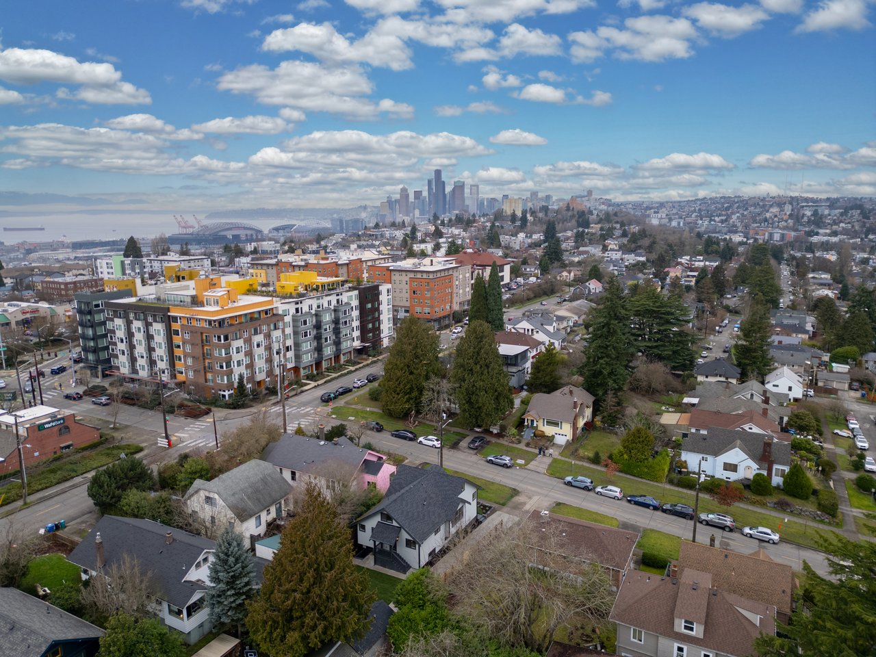 Aerial view of Beacon Hill neighborhood in Seattle with downtown skyline and Elliott Bay in the distance.