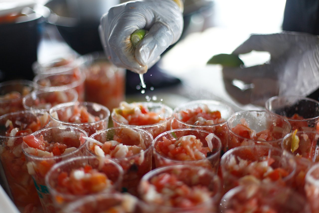 Chef finishing shrimp with lime at a popular Miami waterfront restaurant