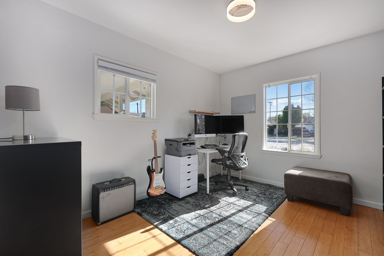 Productive office space with dual-monitor setup, storage wall, and stylish shelving at 17049 Baltar St