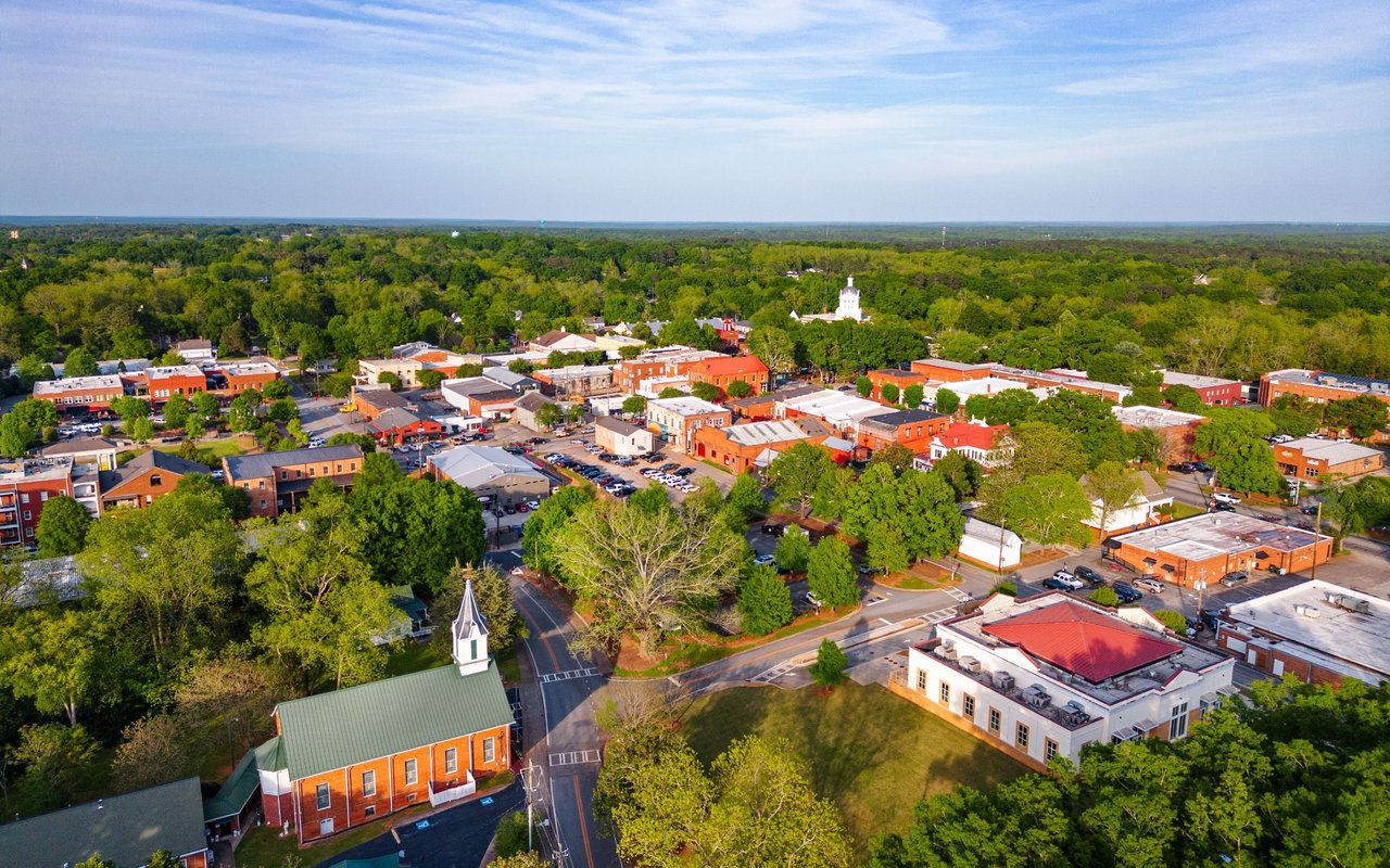 Downtown Madison GA aerial view with historic buildings and tree canopy