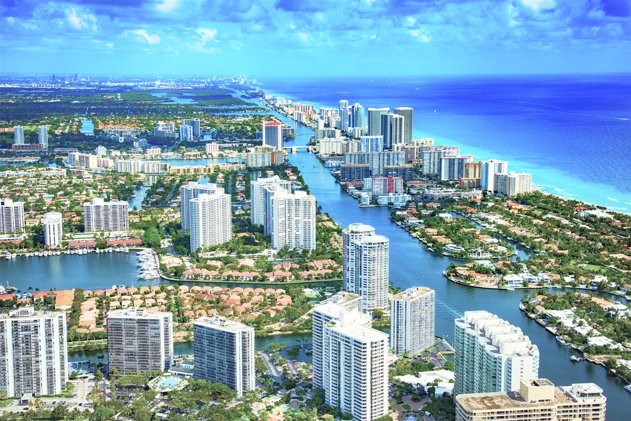 Aerial view of Aventura, Florida showcasing luxury condos, waterfront views, and cityscape