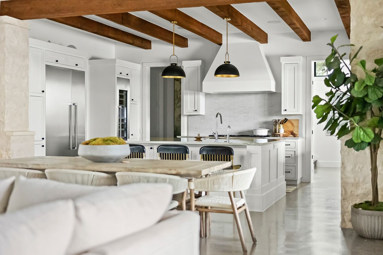 Chef's kitchen with a White Macaubas quartzite island and stainless steel appliances in this Creek Road Ranch home in Dripping Springs, Texas.