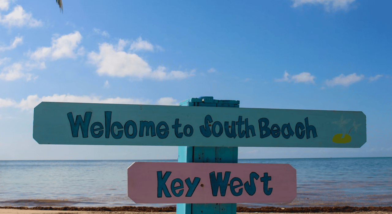 South Beach and Key West signs beside the ocean.