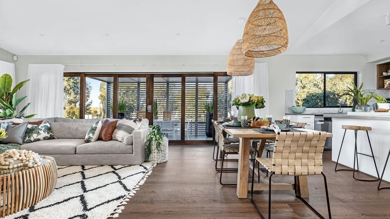 Spacious open living and dining area with high ceilings and contemporary neutral decor in a Silverwood estate, designed for refined family connection.