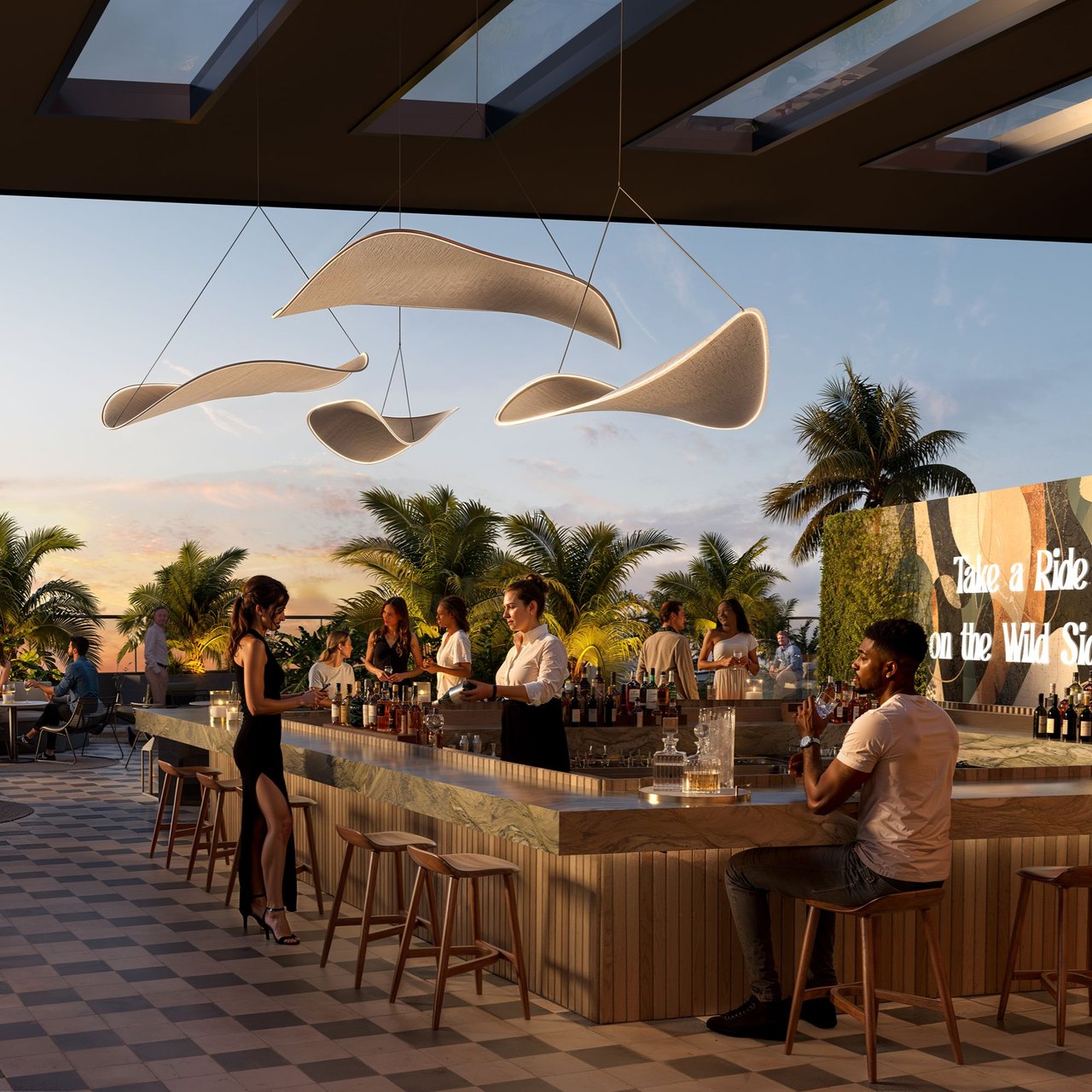 Rooftop bar at The Rider Residences, with a long marble counter, hanging shades, and palm trees.