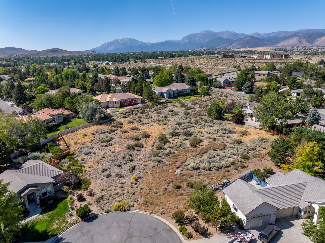 Real estate agent reviewing documents to identify fraud risks, including vacant land scams, title fraud, wire fraud, and buyer scams in a real estate transaction.