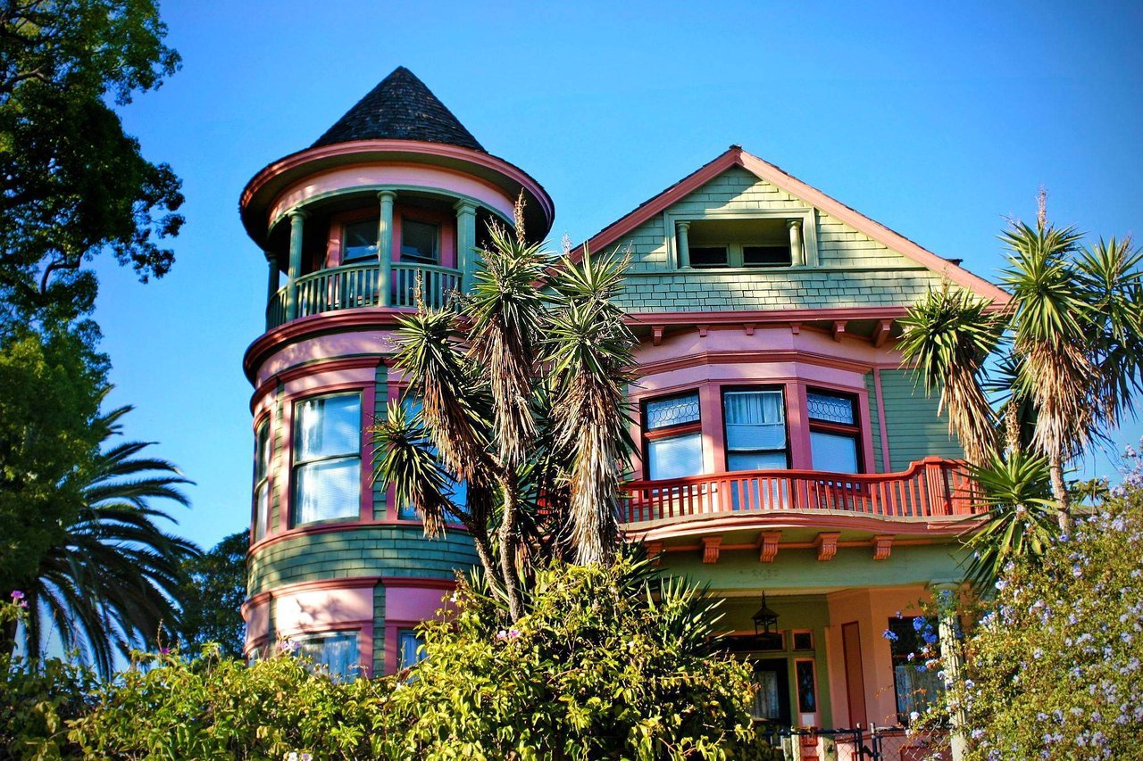 Brightly colored Victorian home in Golden Hill, San Diego surrounded by palm trees and historic charm—representing the neighborhood’s real estate appeal and cultural character.