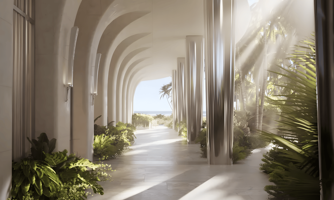 Covered walkway with repeating white arches, tropical plants, and an ocean view at the far end.