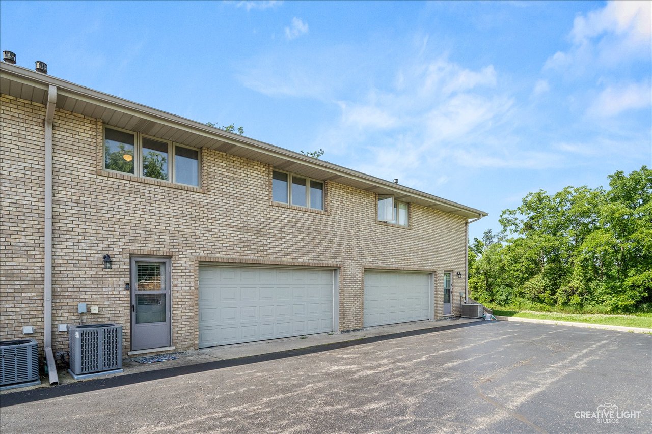 Brick townhouse exterior with attached two car garage at 8316 Woodland Drive Darien IL