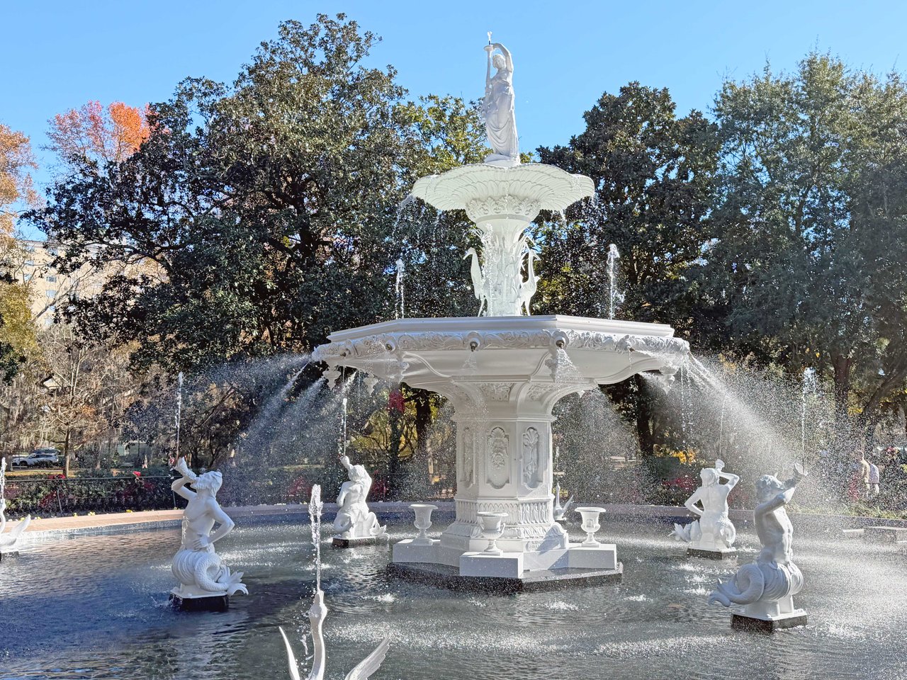 A professional restoration of the Forsyth Park fountain in Savannah, GA, showing the landmark being dismantled and carefully craned for historic preservation.