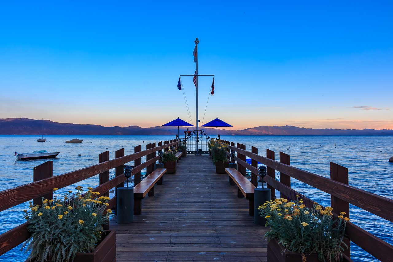Lakeside outdoor dining setup with umbrella tables in Incline Village, Lake Tahoe