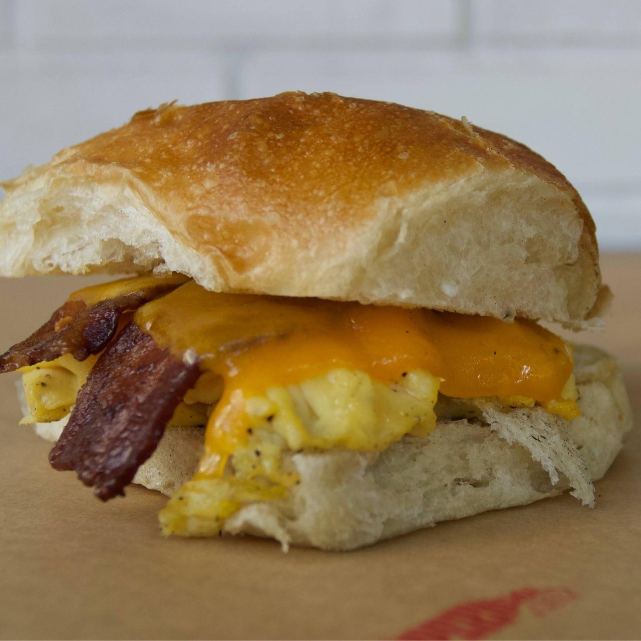 Bacon egg and cheddar breakfast sandwich on focaccia from SuperNatural Food & Wine in Downtown Tampa Florida