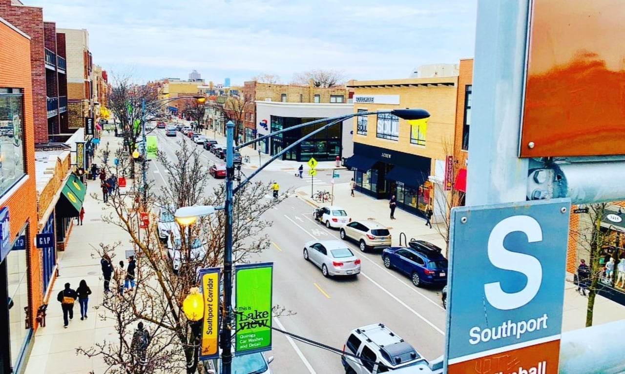 Lakeview’s Southport shopping street, seen from above with storefronts, traffic, and a large Southport sign.