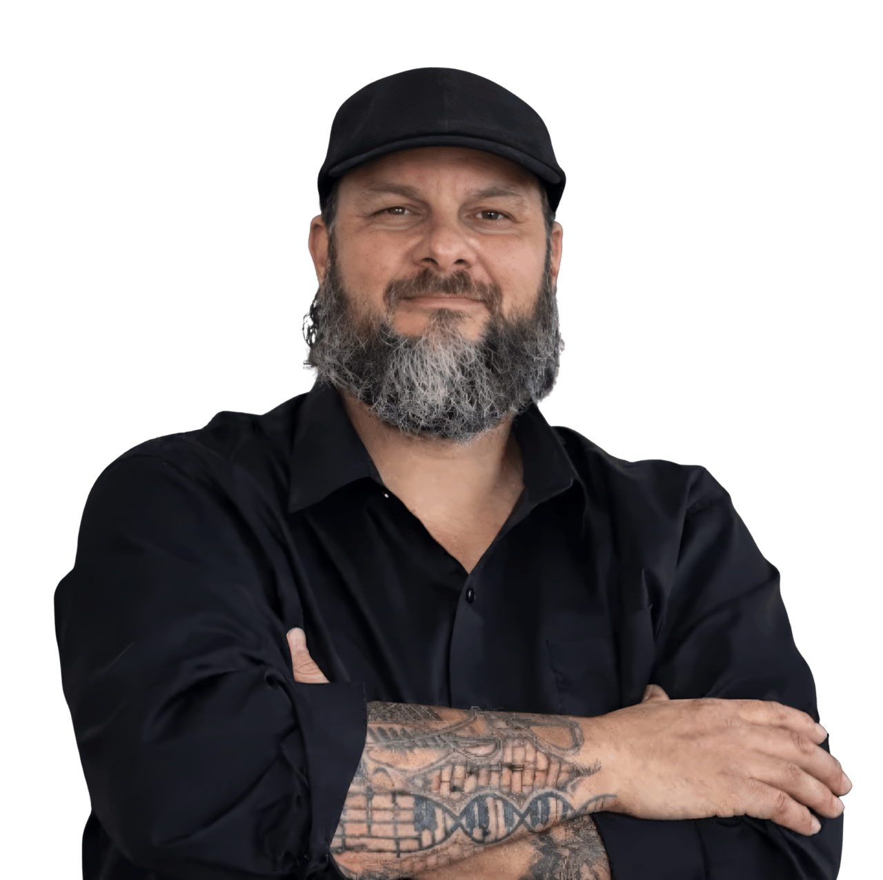 William Ybanez wearing a black cap and shirt, arms crossed, with a tattooed forearm.