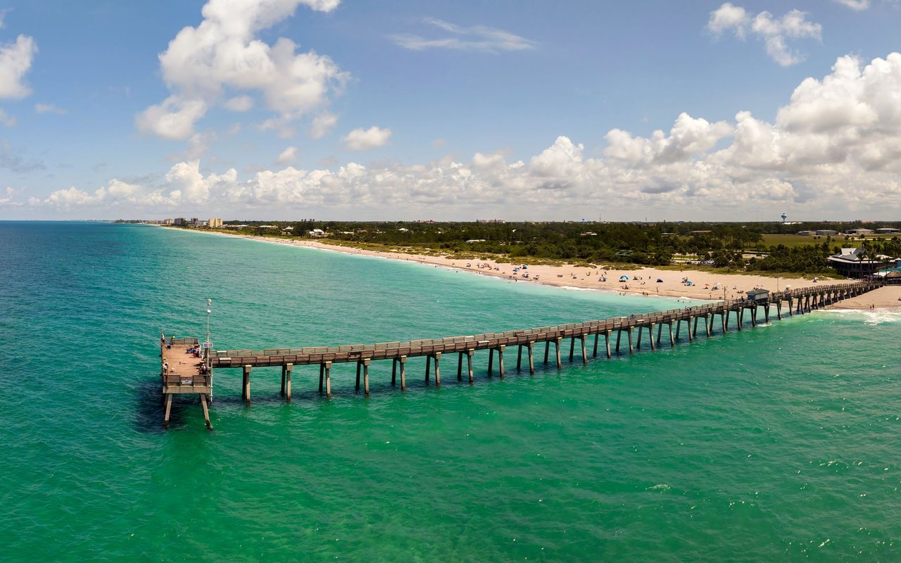 Venice Beach and its long fishing pier stretch along turquoise Gulf waters.