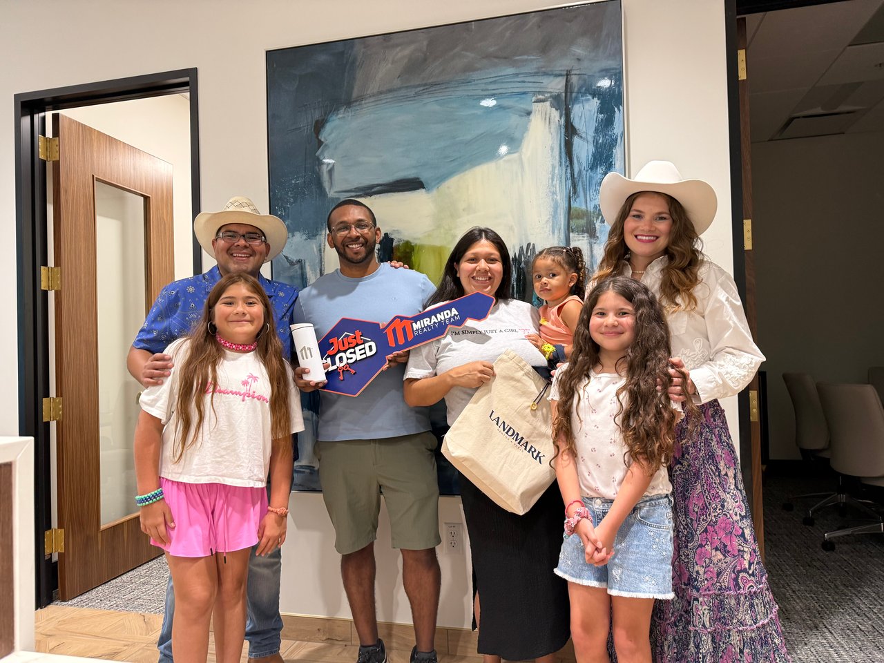Bennett family and Miranda Realty Team celebrating at the title company on closing day. Buying their new home at Landmark by Hillwood in Denton, Texas
