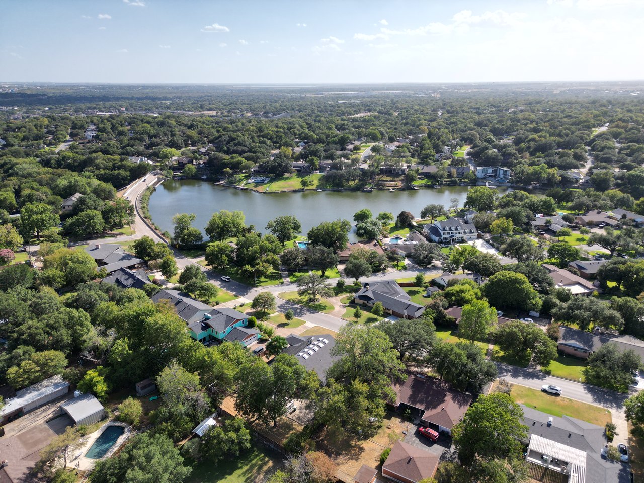 Ridglea homes and tree-lined streets surrounding a lake, seen from above.