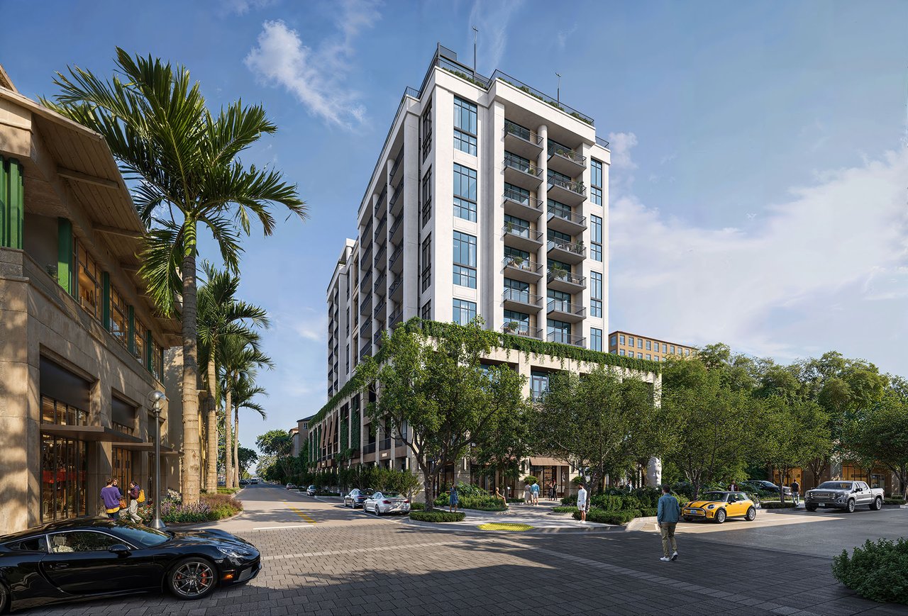 Cora Residences condominium building with balconies, palm trees, and a landscaped street entrance.