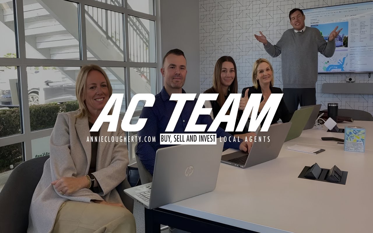  A diverse team of five professionals sits at a conference table, with a large "AC TEAM" logo superimposed on the image.