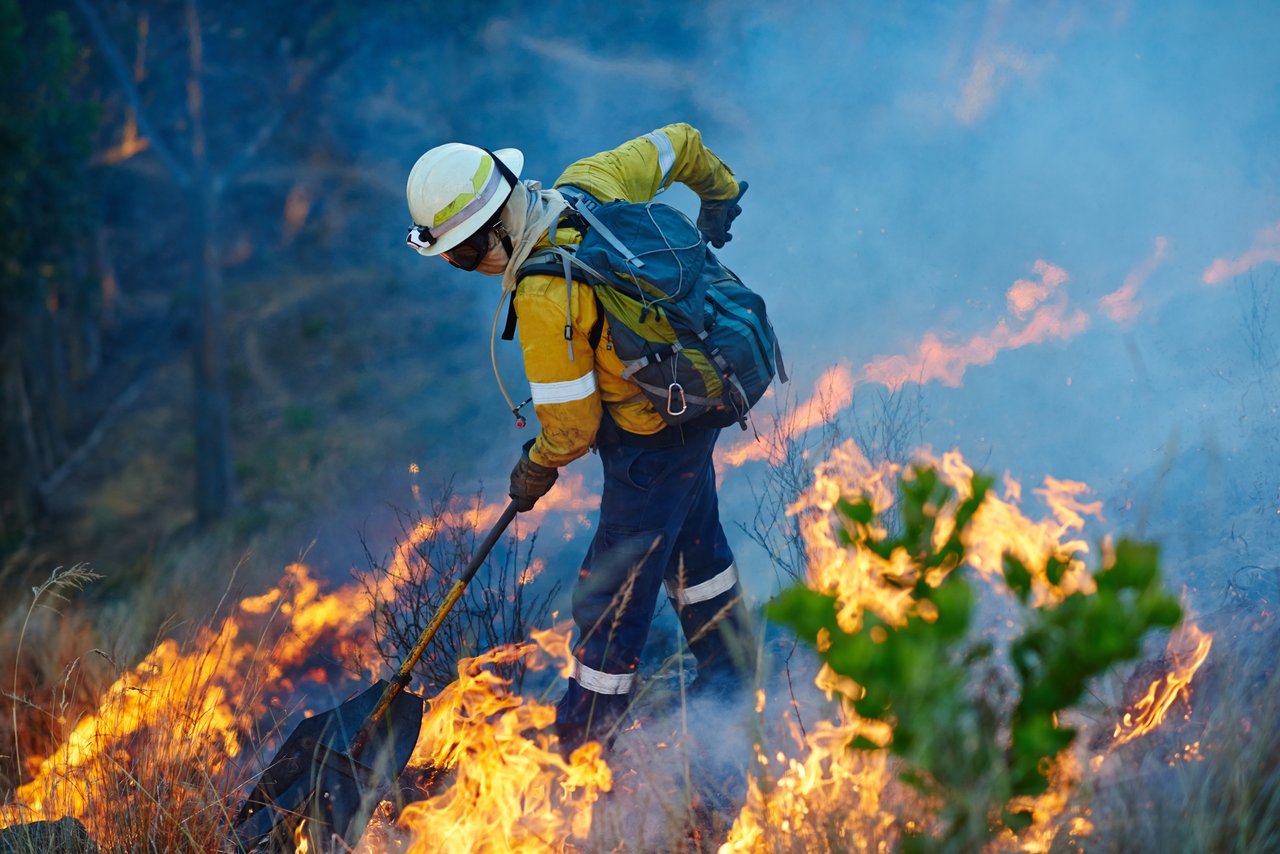 Firefighter working to protect Lake Tahoe homes from a forest fire.