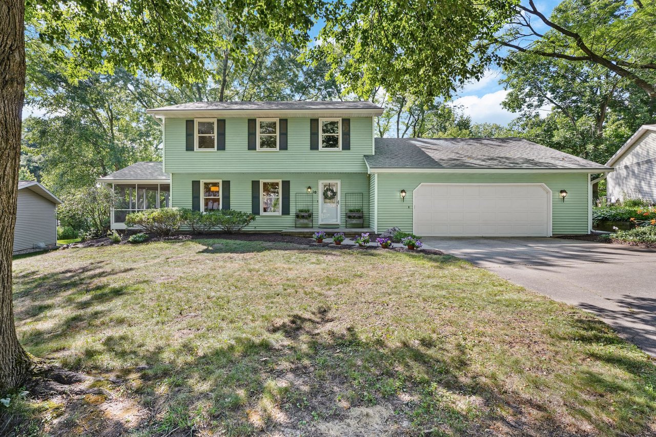 Front exterior of 10 Stonecrest Circle, a two-story colonial on a quiet cul-de-sac in the Walnut Grove neighborhood of Madison, WI, with a two-car attached garage and mature trees.