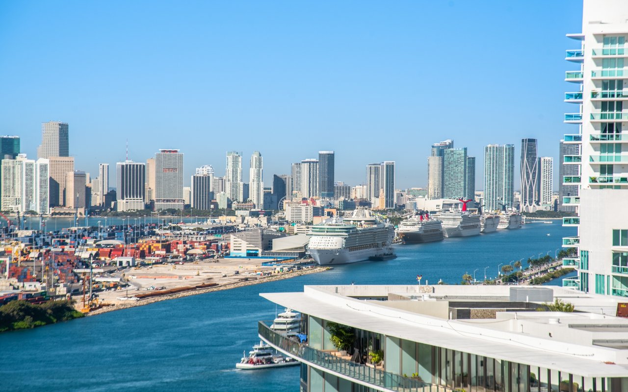 Miami waterfront skyline with cruise ships docked along the port.