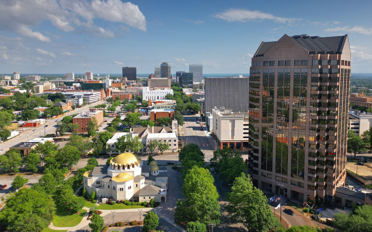 Downtown Columbia skyline with a gold-domed church in the foreground.
