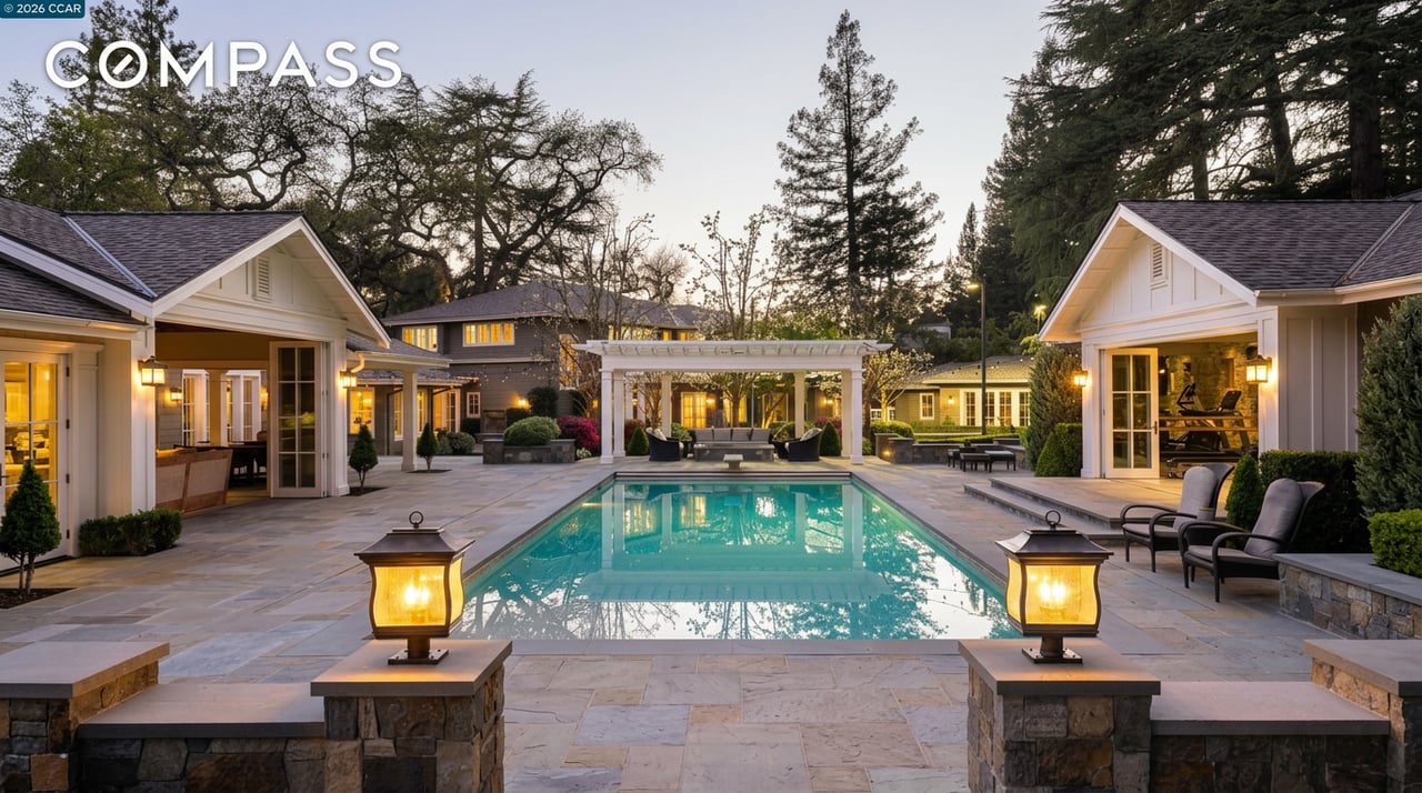 Outdoor courtyard and swimming pool surrounded by travertine pavers, a white pergola, and pool houses at 1817 Calle Arroyo in Diablo, California
