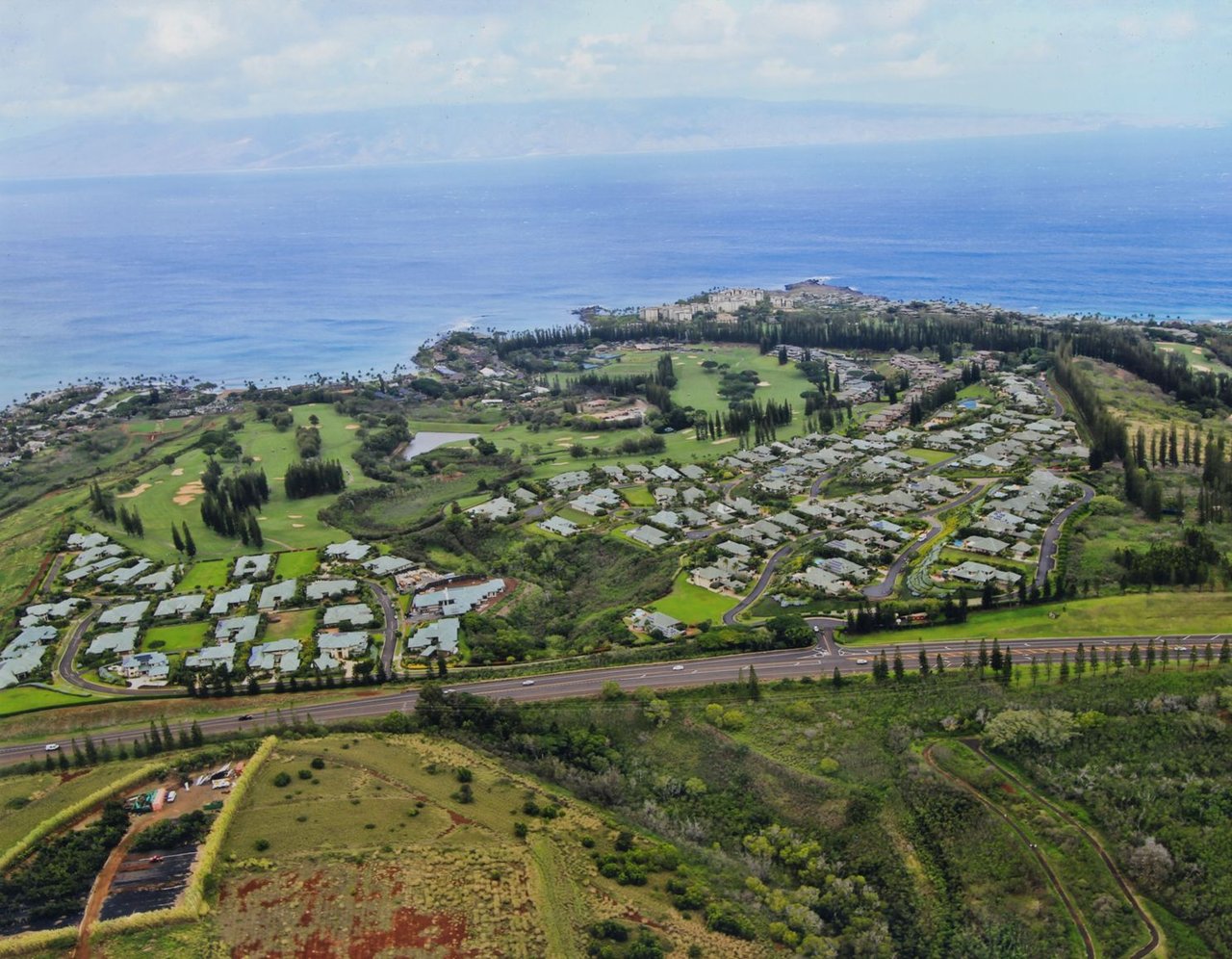 aerial image of pineapple hill in kapalua with bay course in foreground
