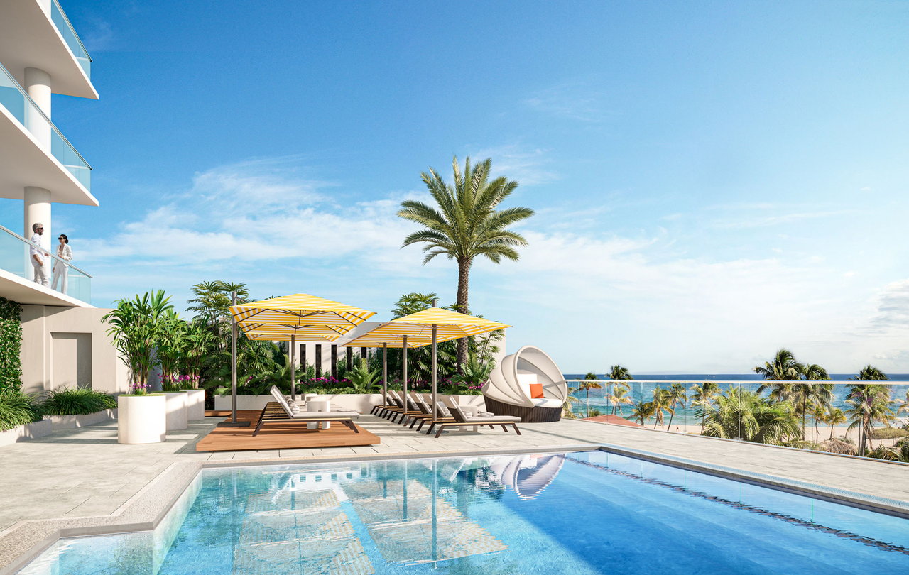 Salato Residences pool terrace with striped umbrellas, palm trees, and an ocean view.