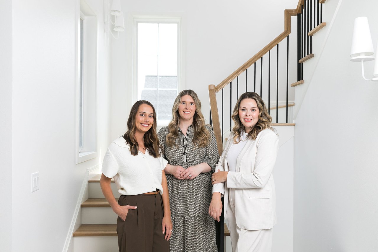 Cait Berry and the Insiders Realty team standing together in a bright, modern interior, representing the expert strategy and local guidance needed to navigate the Sun Prairie, WI real estate market in 2026.