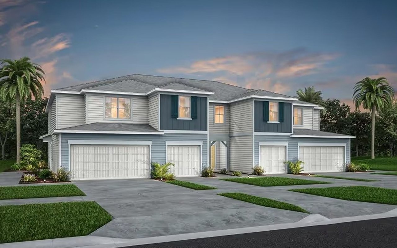 Two-story attached homes with teal accents, multiple garages, landscaped lawns, and palm trees.
