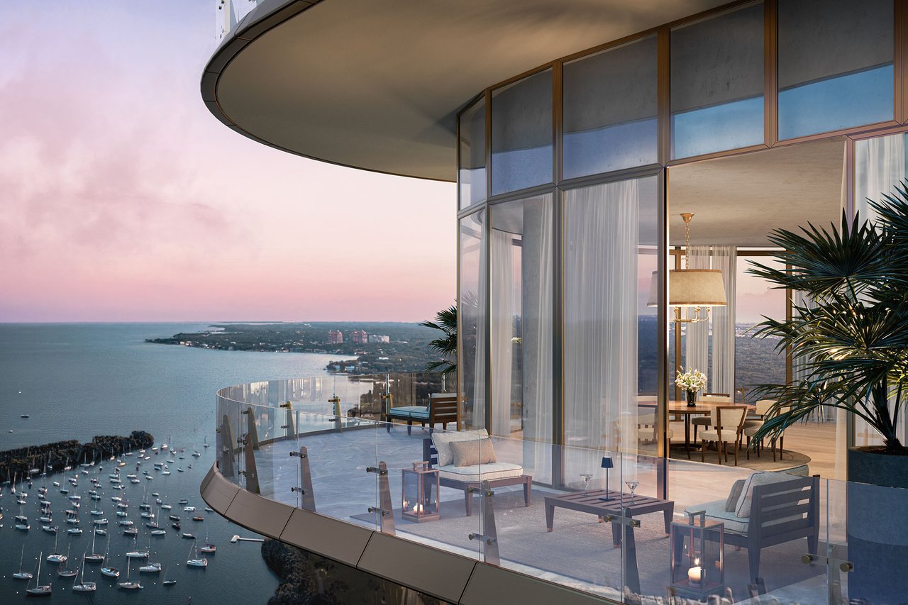 Luxury residence balcony overlooking Biscayne Bay and a marina at dusk.
