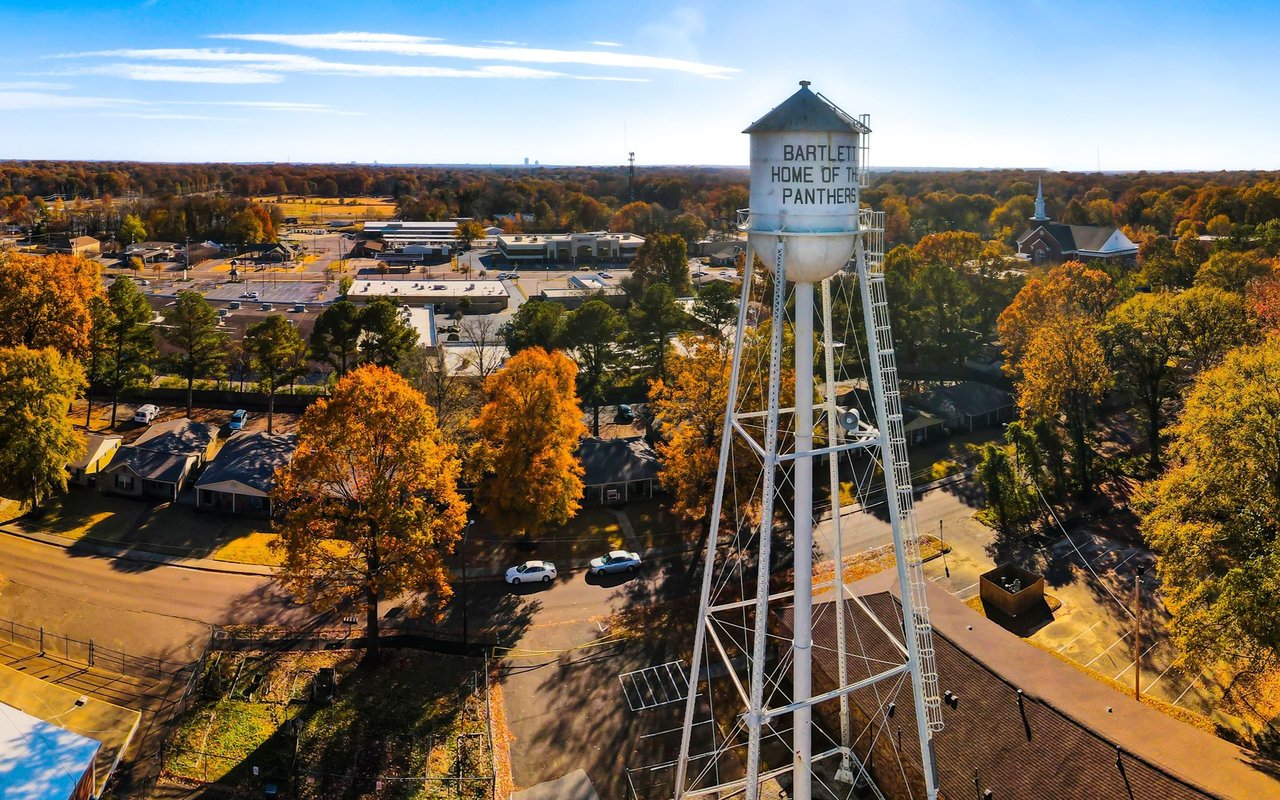 Aerial view of Bartlett, featuring its water tower and autumn-colored trees.