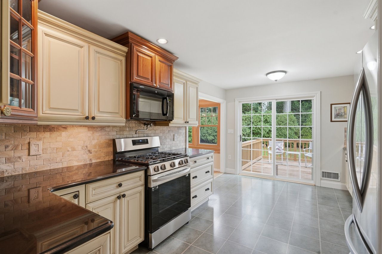 Kitchen view leading to dining room and outside deckdeck