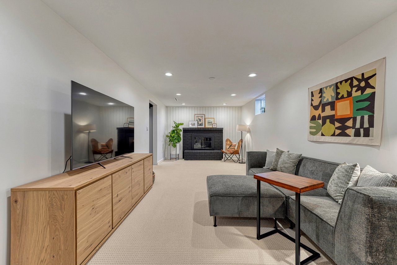 Lower-level family room looking toward the painted brick fireplace