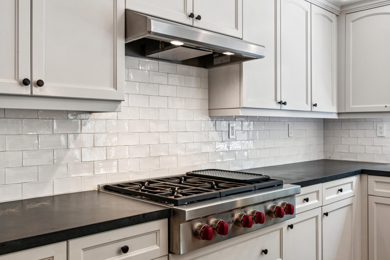 Modern kitchen featuring premium Wolf appliances, ample workspace, and abundant natural light.