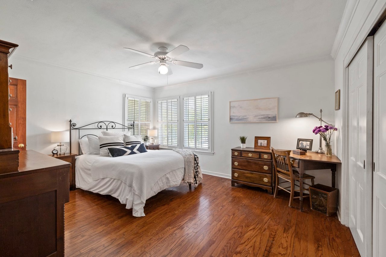 Bedroom with original wood floors and a ceiling fan, Tarrytown, Austin.