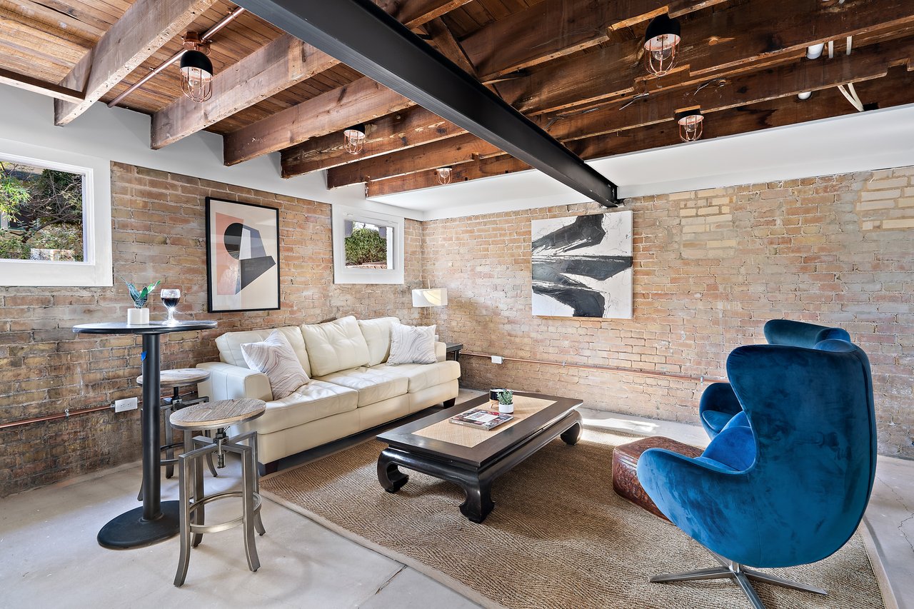 Floating staircase in the open-concept layout of the historic home at 701 Highland Ave Unit #1, Clarksville, Austin, Texas.