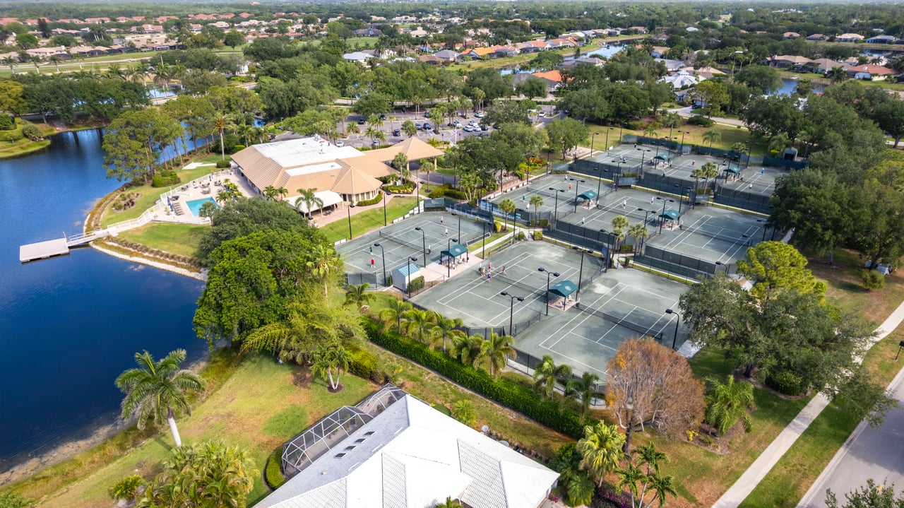 Overhead shot of tennis courts and lakeside amenities in Longshore Lake, Naples FL