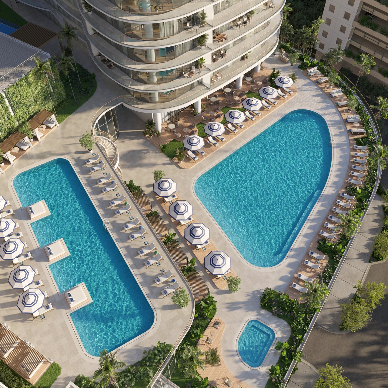 Aerial view of Cipriani Residences’ landscaped pool deck with curved pools, striped umbrellas, and tower balconies.