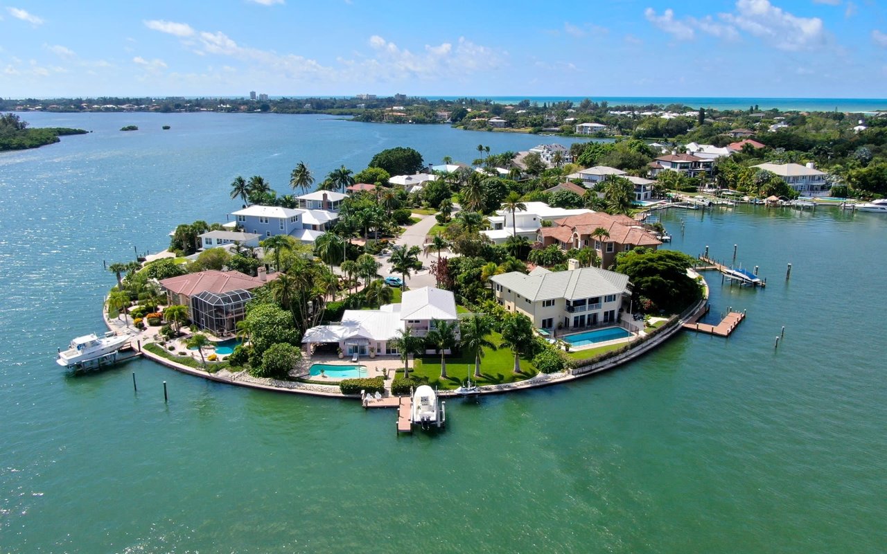 Aerial view of waterfront homes with pools and boat docks