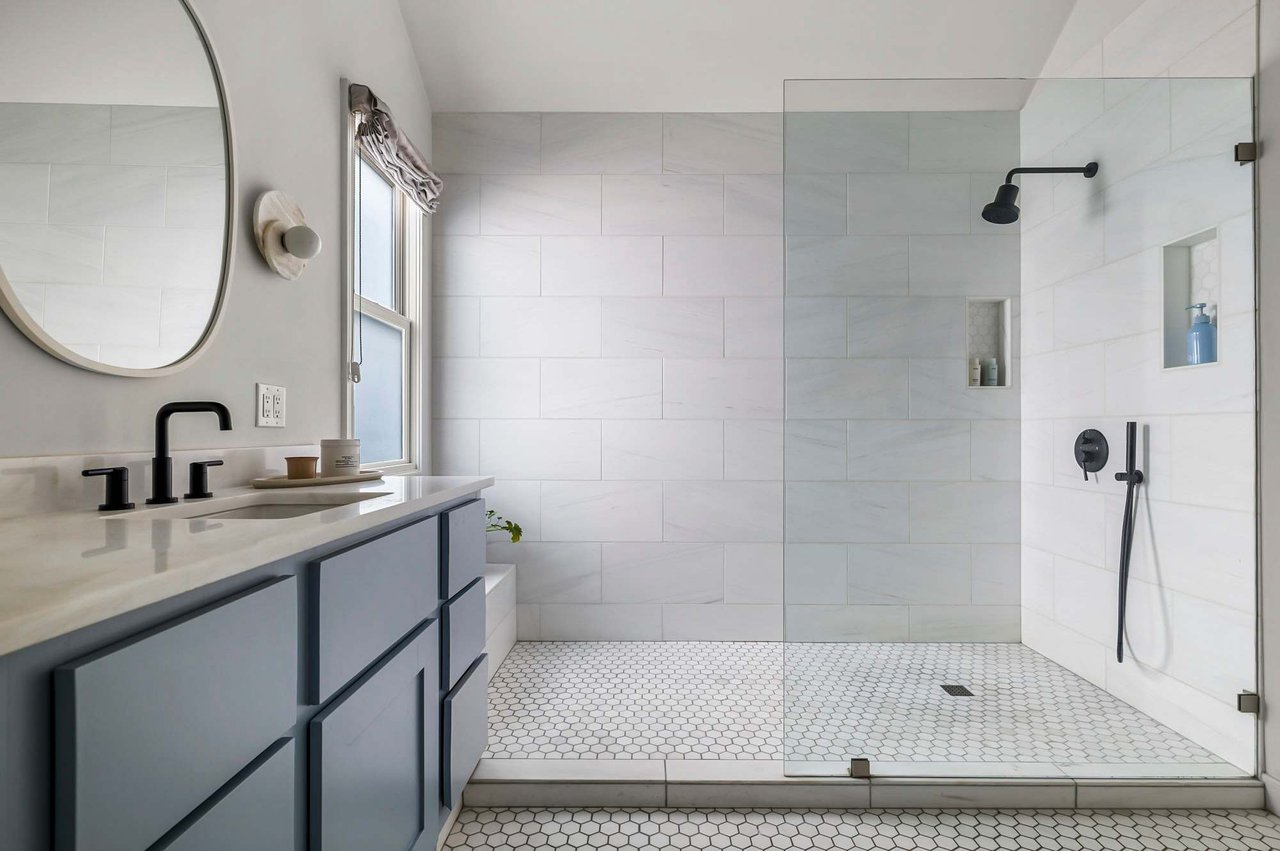 Primary bath walk-in shower with glass door at 1500 Northwood Rd, Pemberton Heights, Austin. Renovation by McWalters Collaborative.